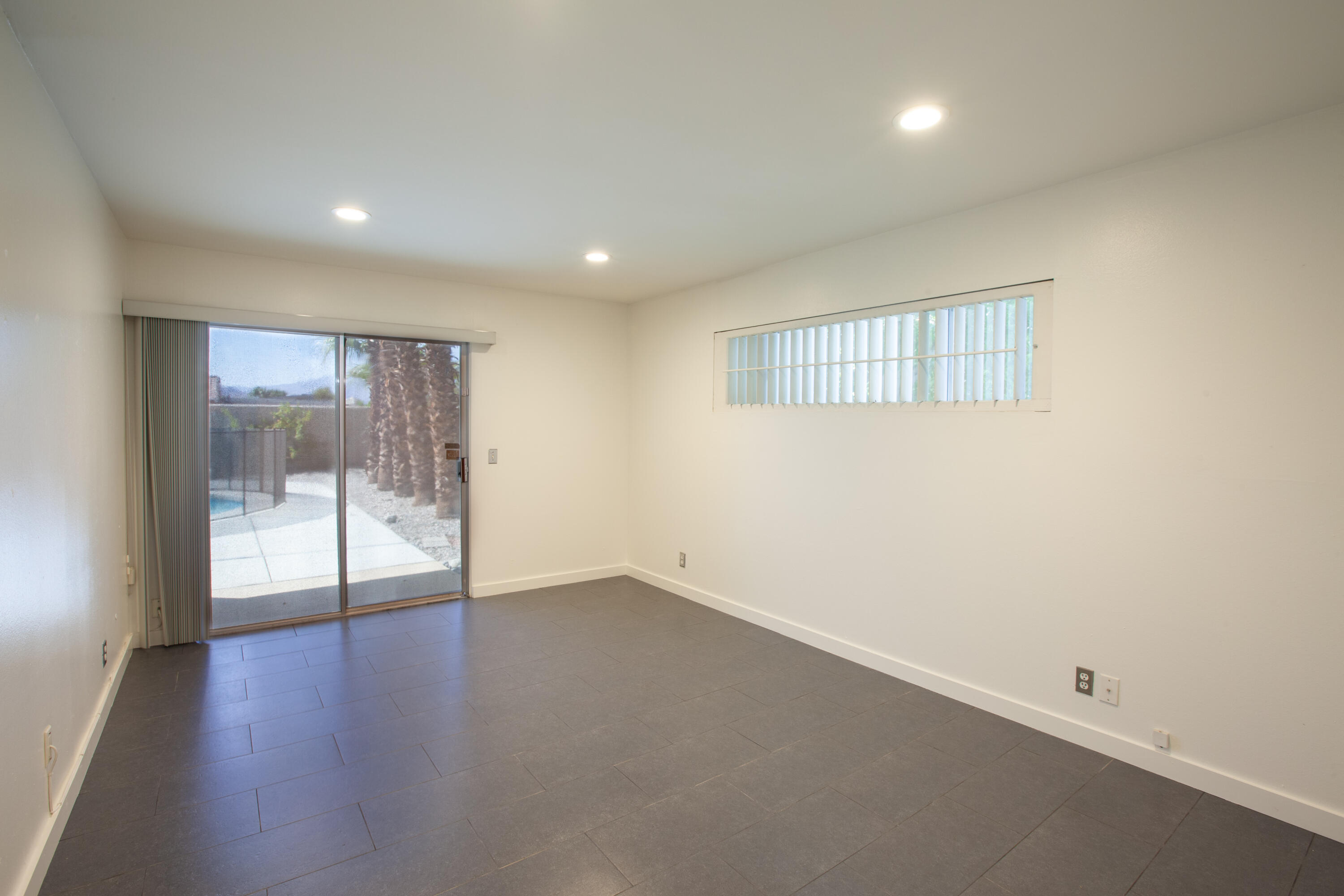 3033 East Verona Road Palm Springs, CA 92262 - Photo 13 of 23 an empty room with wooden floor and windows