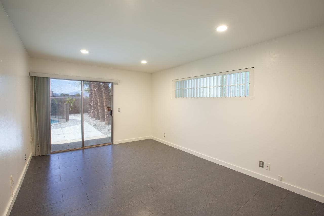 3033 East Verona Road Palm Springs, CA 92262 - Photo 15 of 23 an empty room with wooden floor and windows