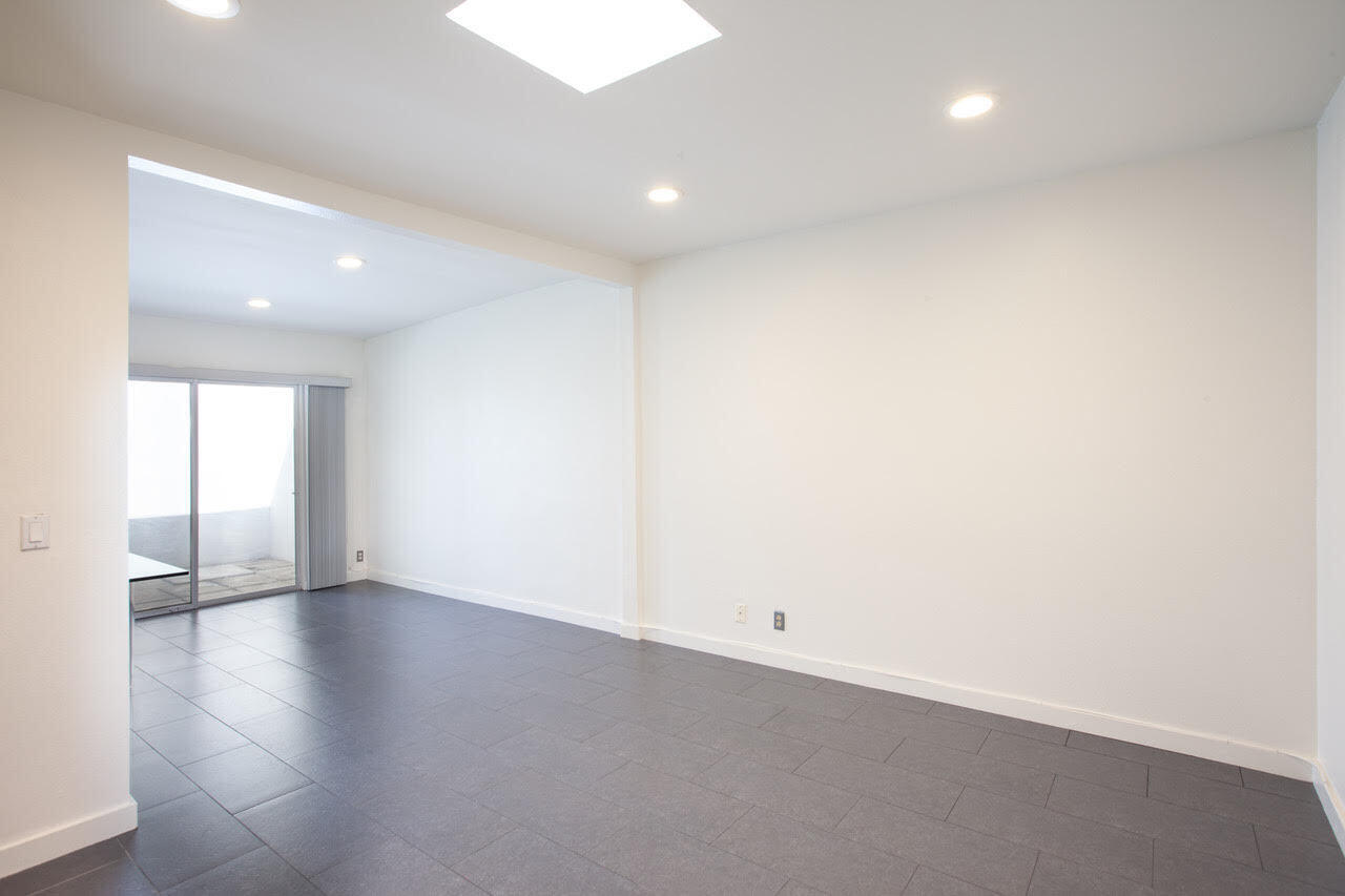 3033 East Verona Road Palm Springs, CA 92262 - Photo 17 of 23 an empty room with wooden floor and windows