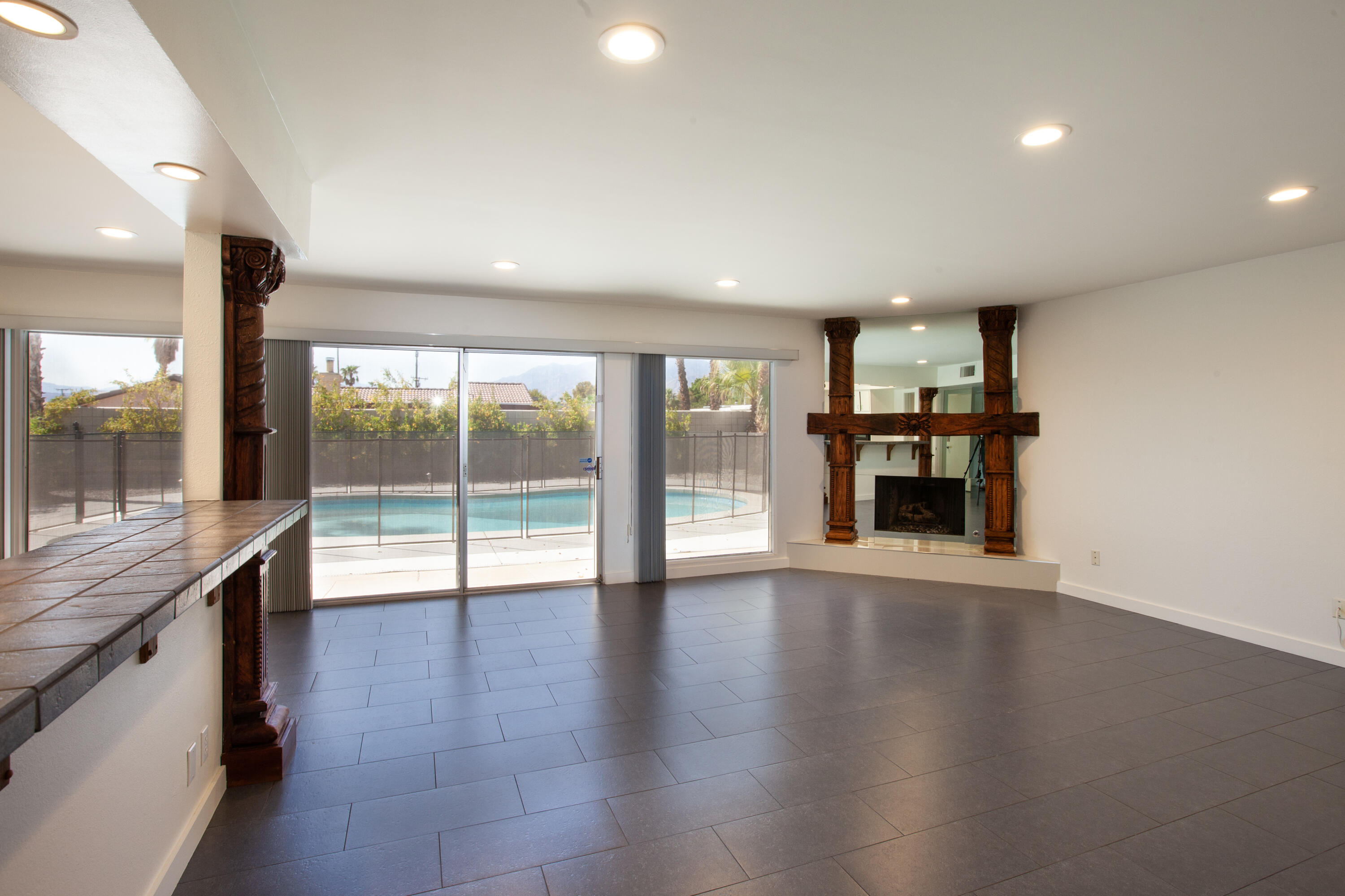 3033 East Verona Road Palm Springs, CA 92262 - Photo 4 of 23 a view of an empty room with wooden floor and a window