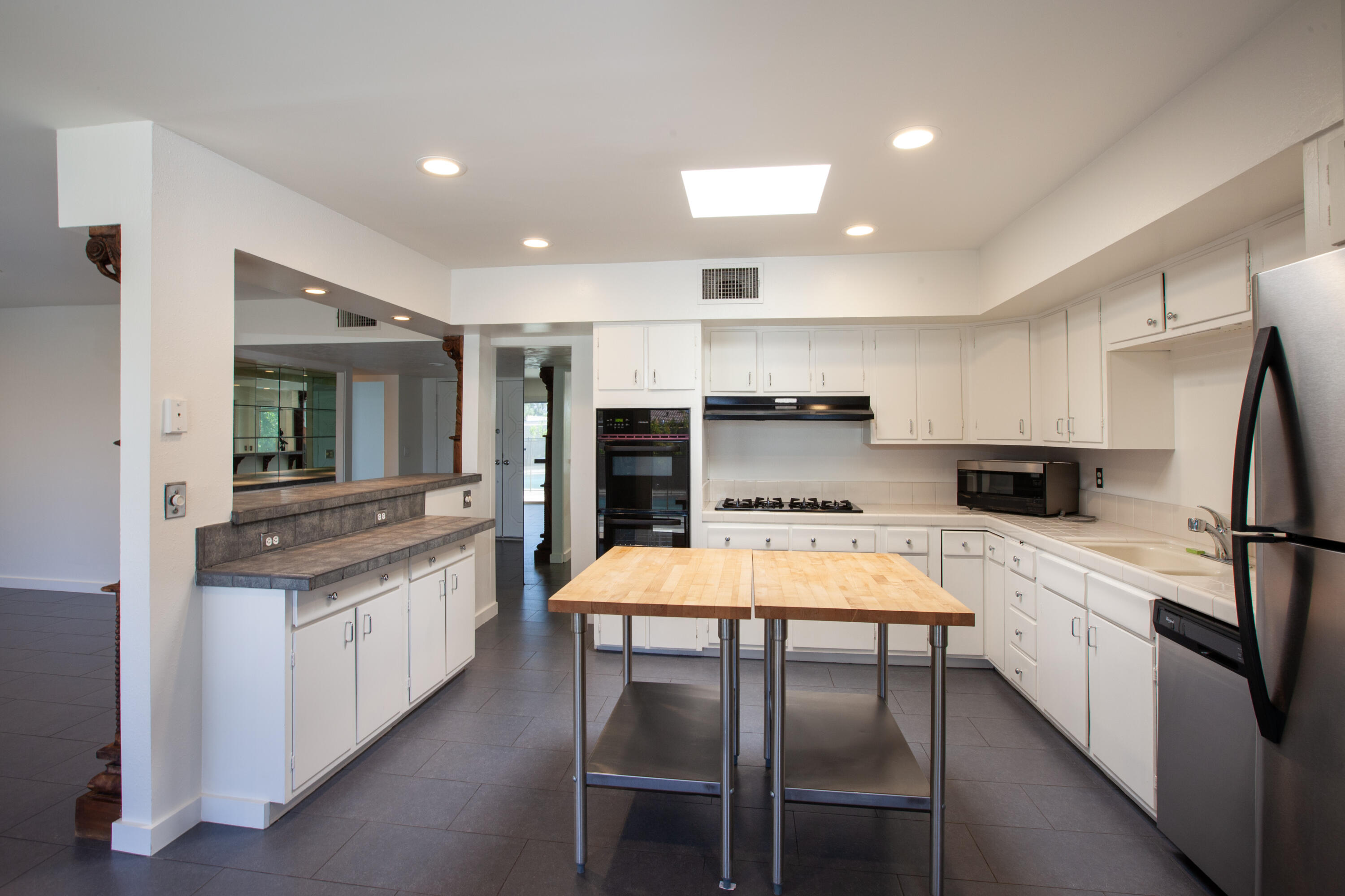 3033 East Verona Road Palm Springs, CA 92262 - Photo 5 of 23 a kitchen with stainless steel appliances a refrigerator stove microwave and white cabinets