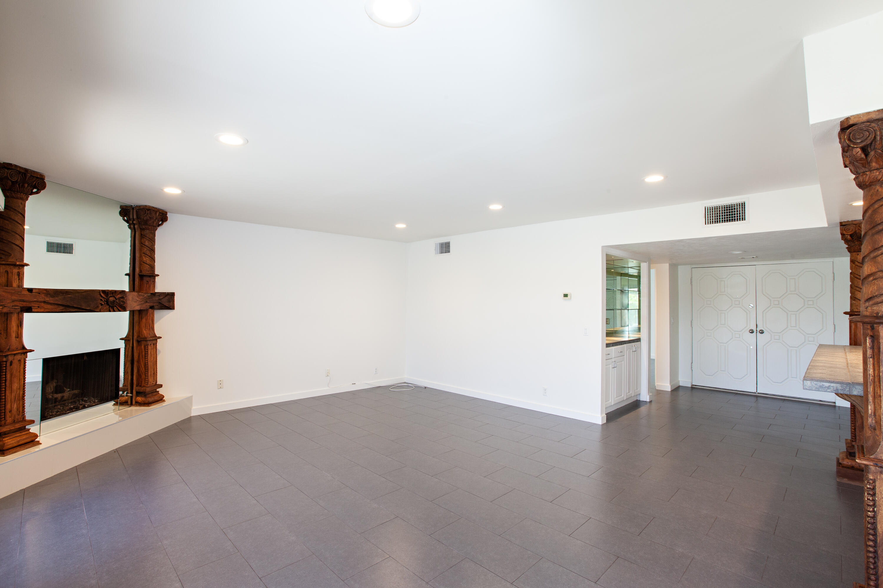 3033 East Verona Road Palm Springs, CA 92262 - Photo 8 of 23 an empty room with a fireplace and window