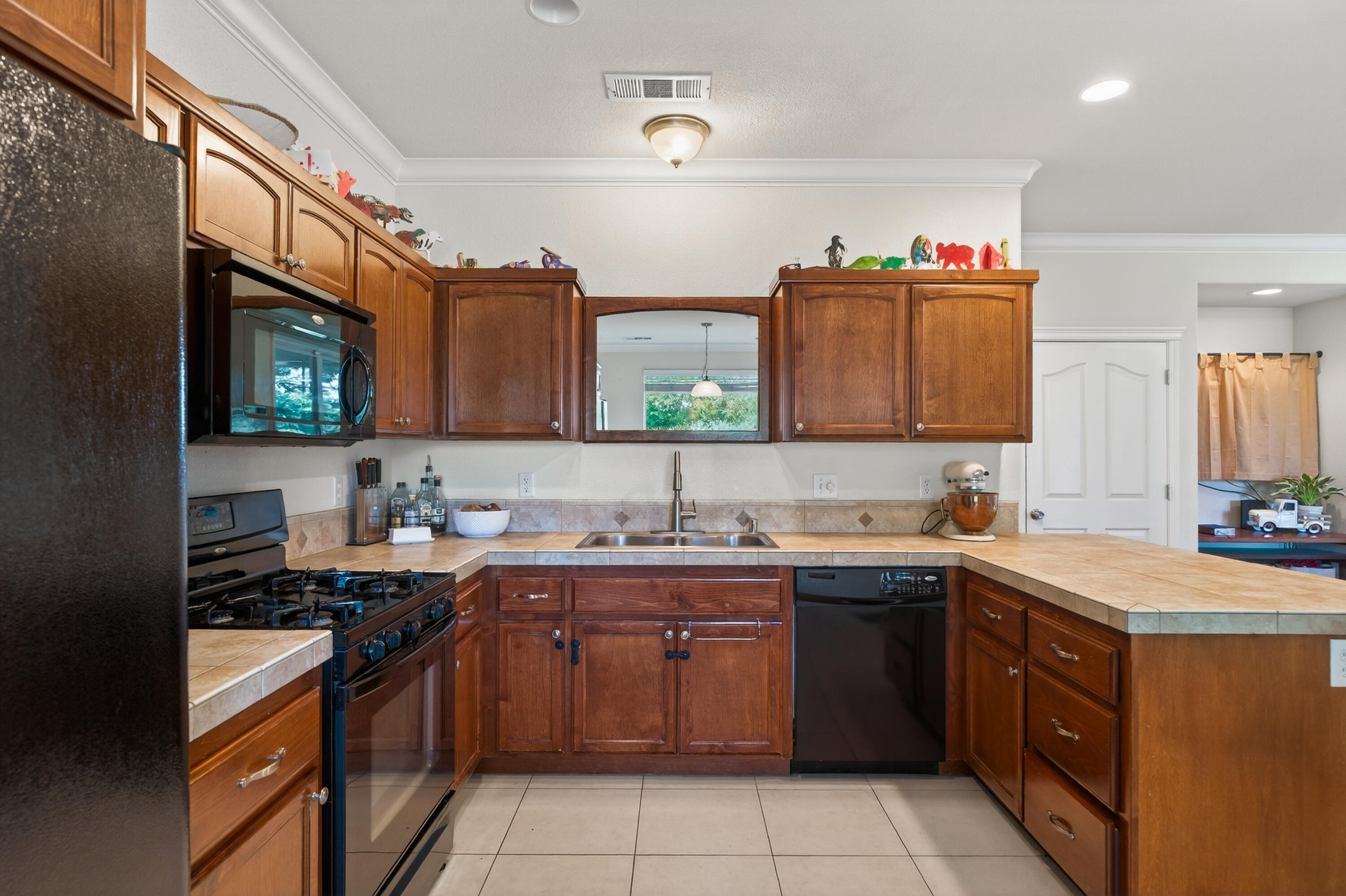 2090 Tuscany Way Redding, CA 96003 - Photo 14 of 37 a kitchen with a sink stove top oven and cabinets