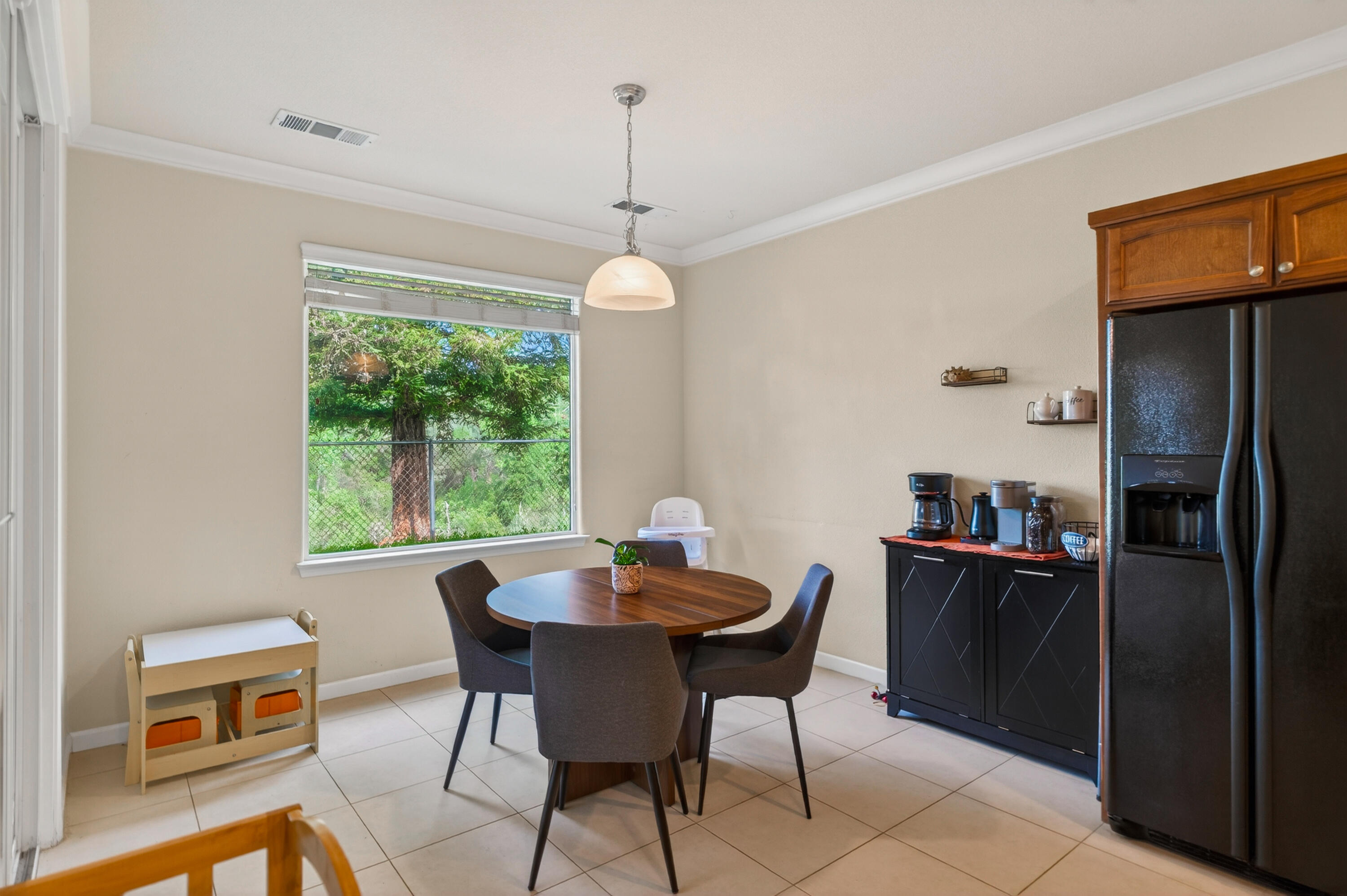 2090 Tuscany Way Redding, CA 96003 - Photo 16 of 37 a dining room with furniture a chandelier and window