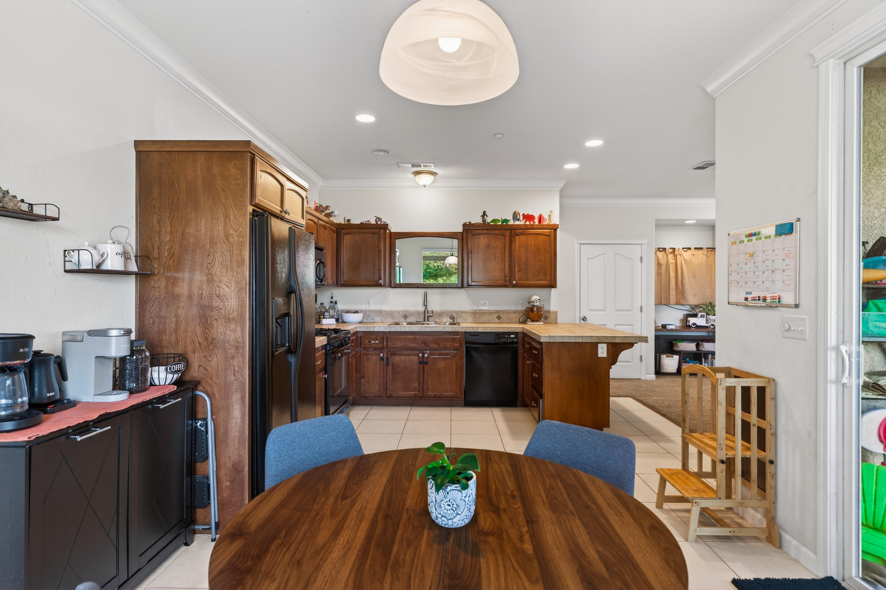 2090 Tuscany Way Redding, CA 96003 - Photo 17 of 37 a large kitchen with stainless steel appliances kitchen island granite countertop a refrigerator and a stove top oven