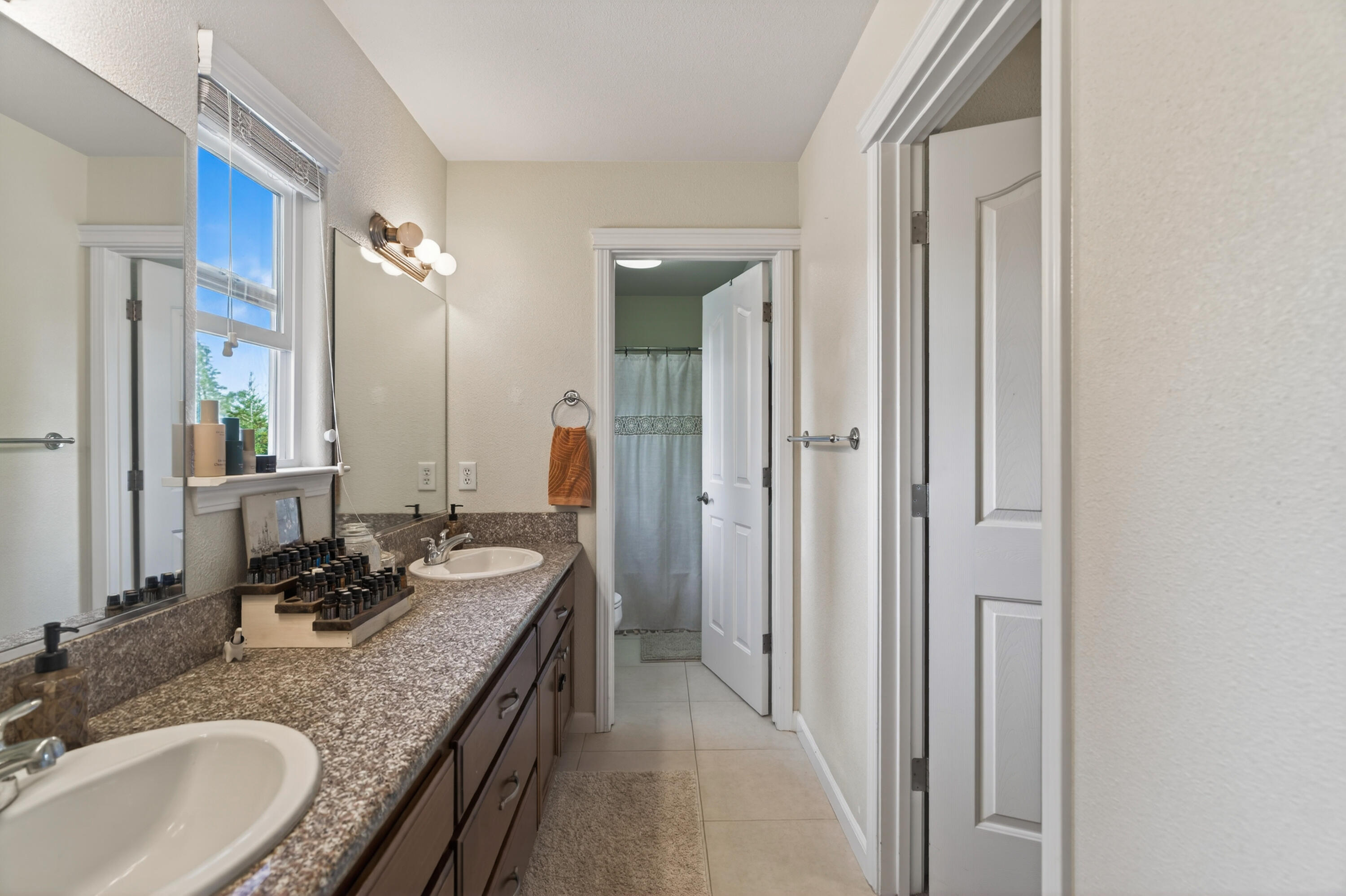 2090 Tuscany Way Redding, CA 96003 - Photo 23 of 37 a bathroom with a granite countertop double vanity sink and a mirror