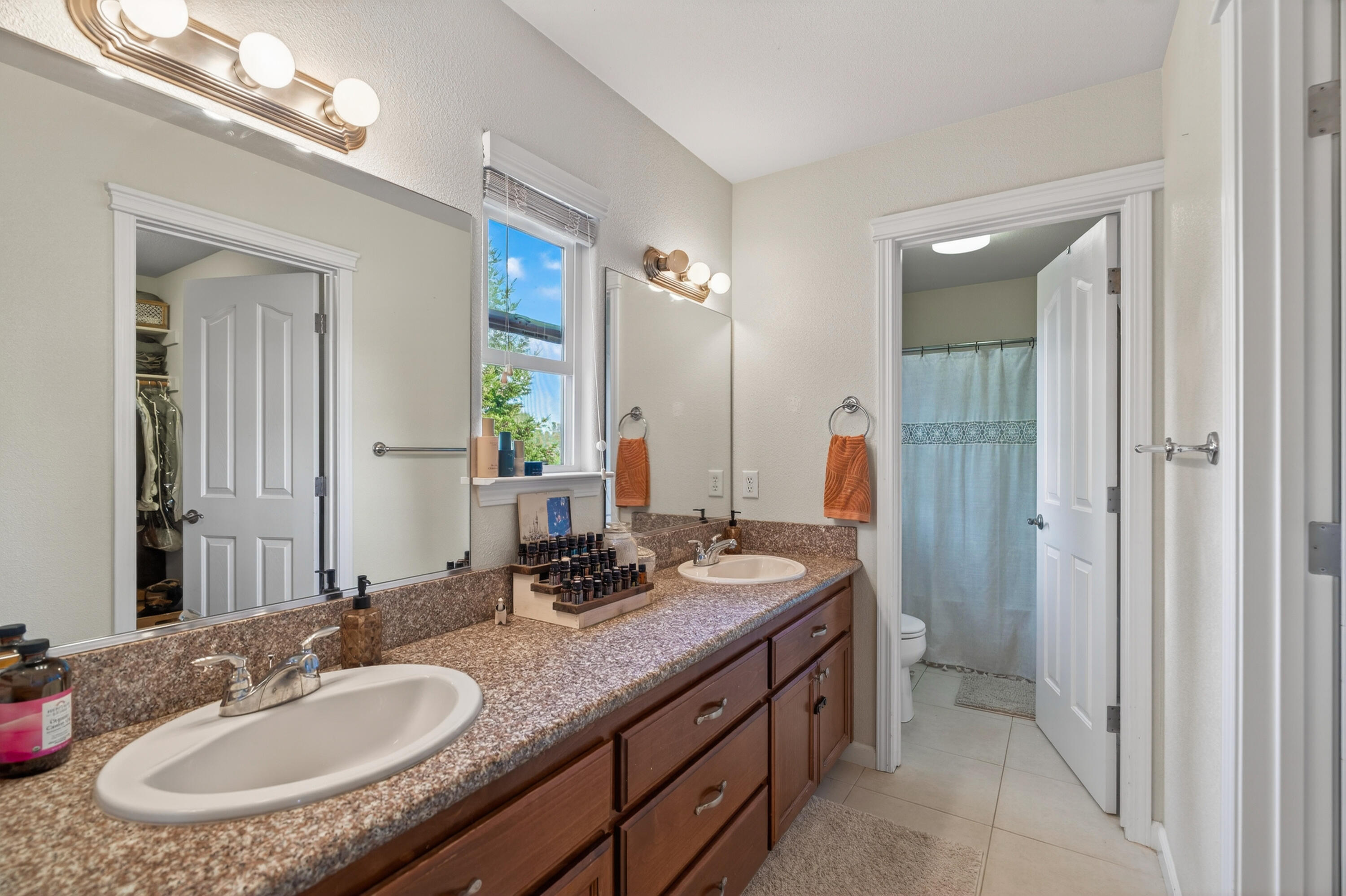 2090 Tuscany Way Redding, CA 96003 - Photo 24 of 37 a bathroom with a granite countertop sink and a mirror