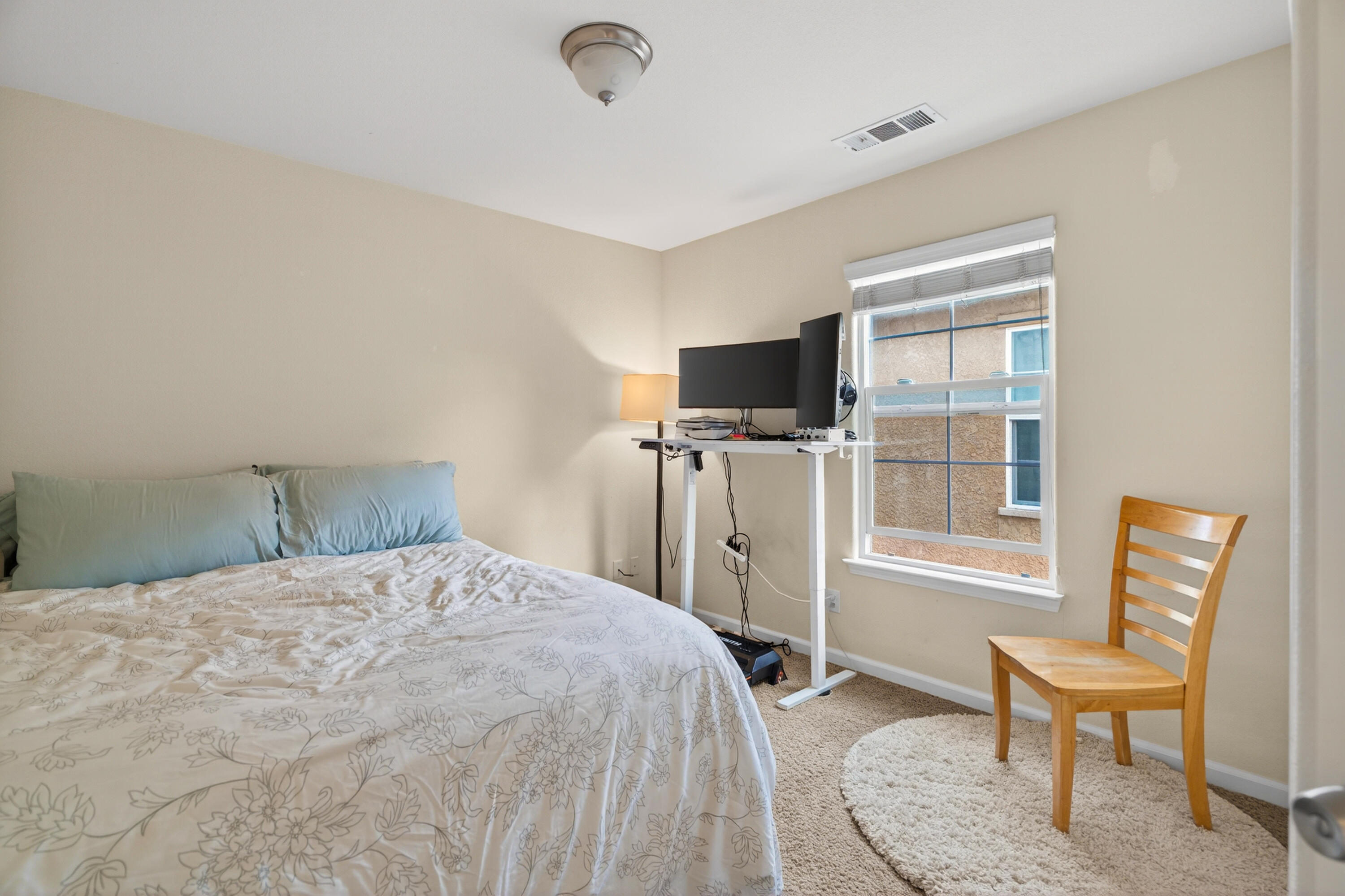 2090 Tuscany Way Redding, CA 96003 - Photo 27 of 37 a bedroom with a bed and a flat screen tv