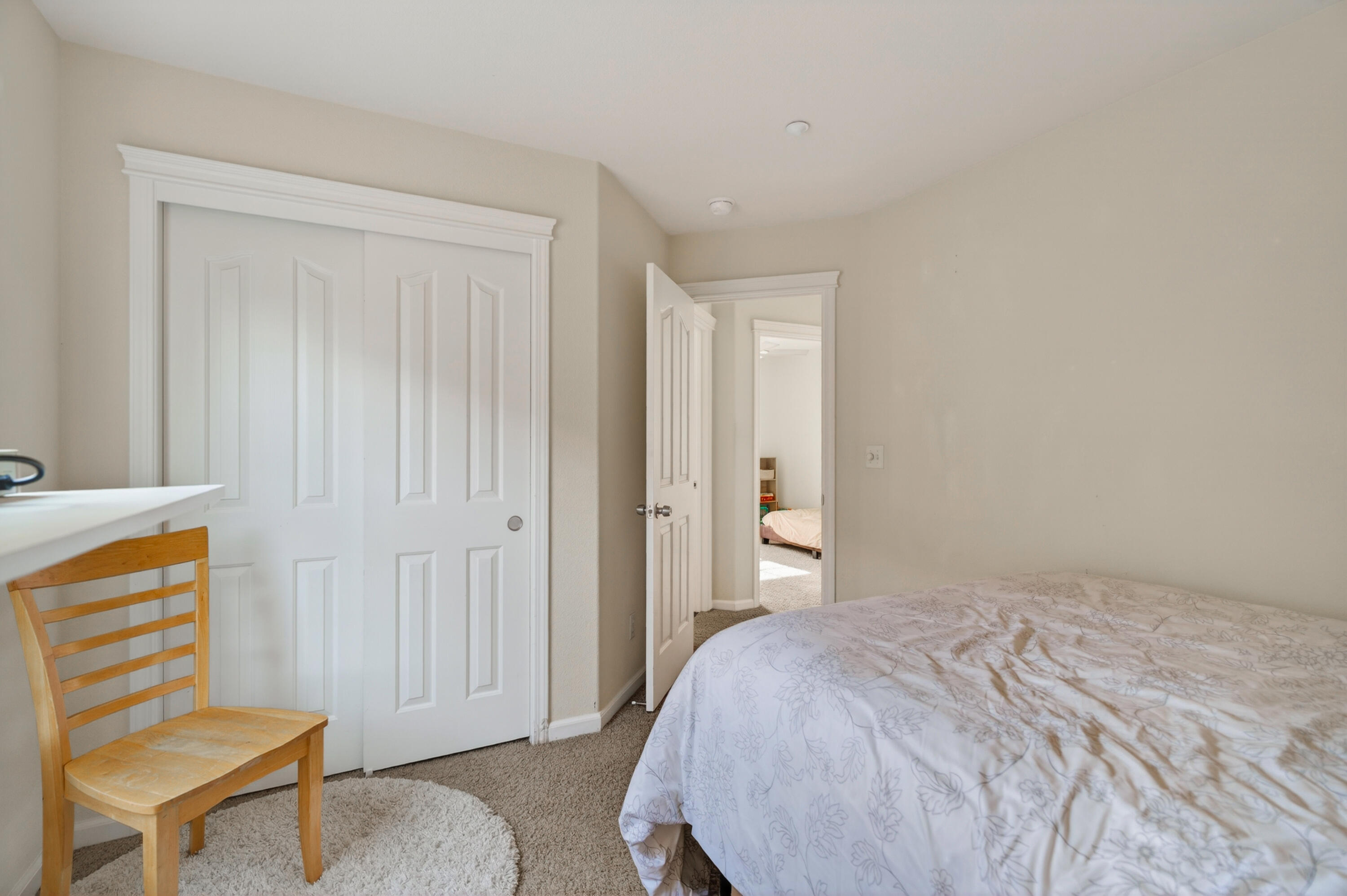 2090 Tuscany Way Redding, CA 96003 - Photo 28 of 37 a bedroom with a bed and chair