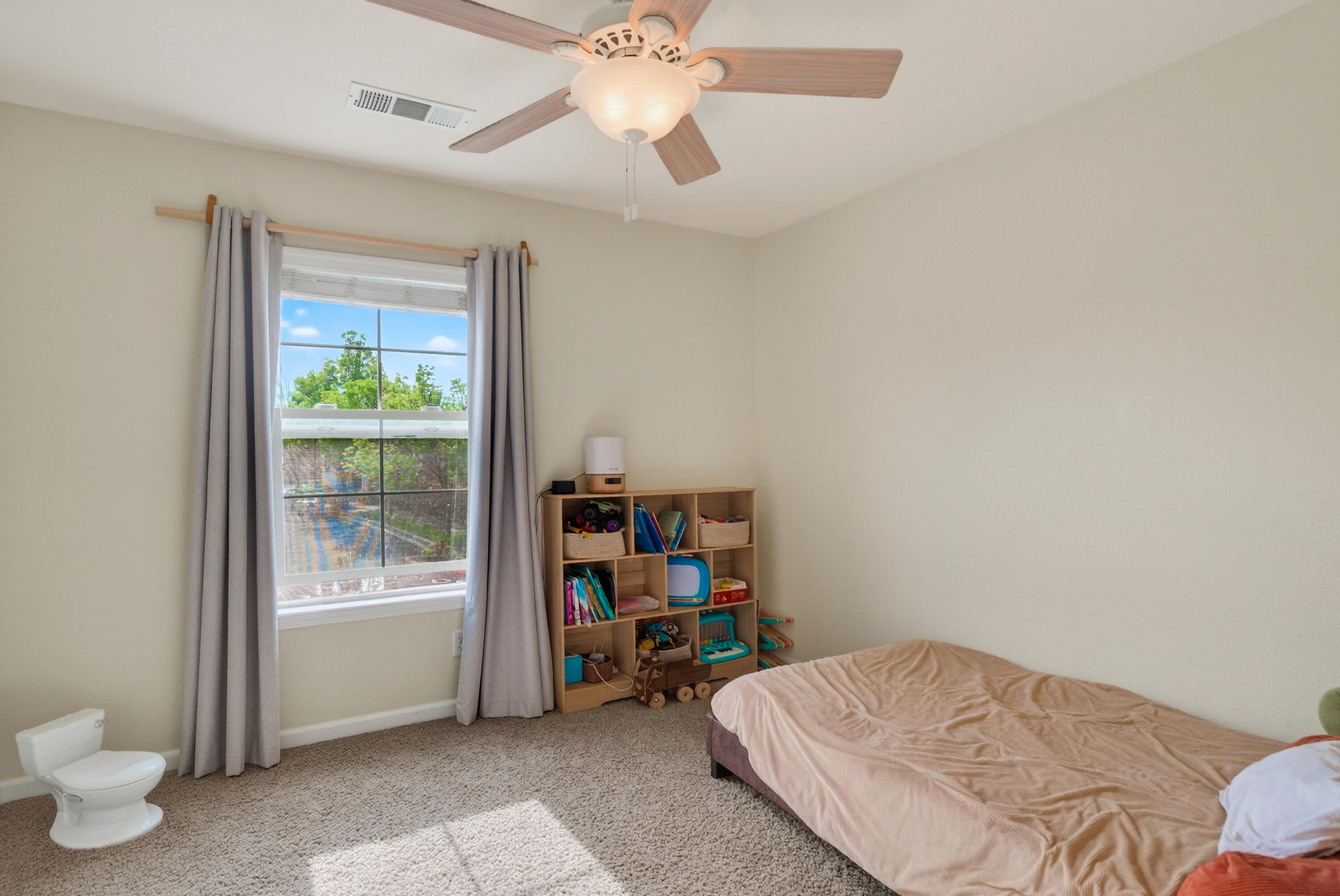 2090 Tuscany Way Redding, CA 96003 - Photo 30 of 37 a bedroom with a bed and a bookshelf