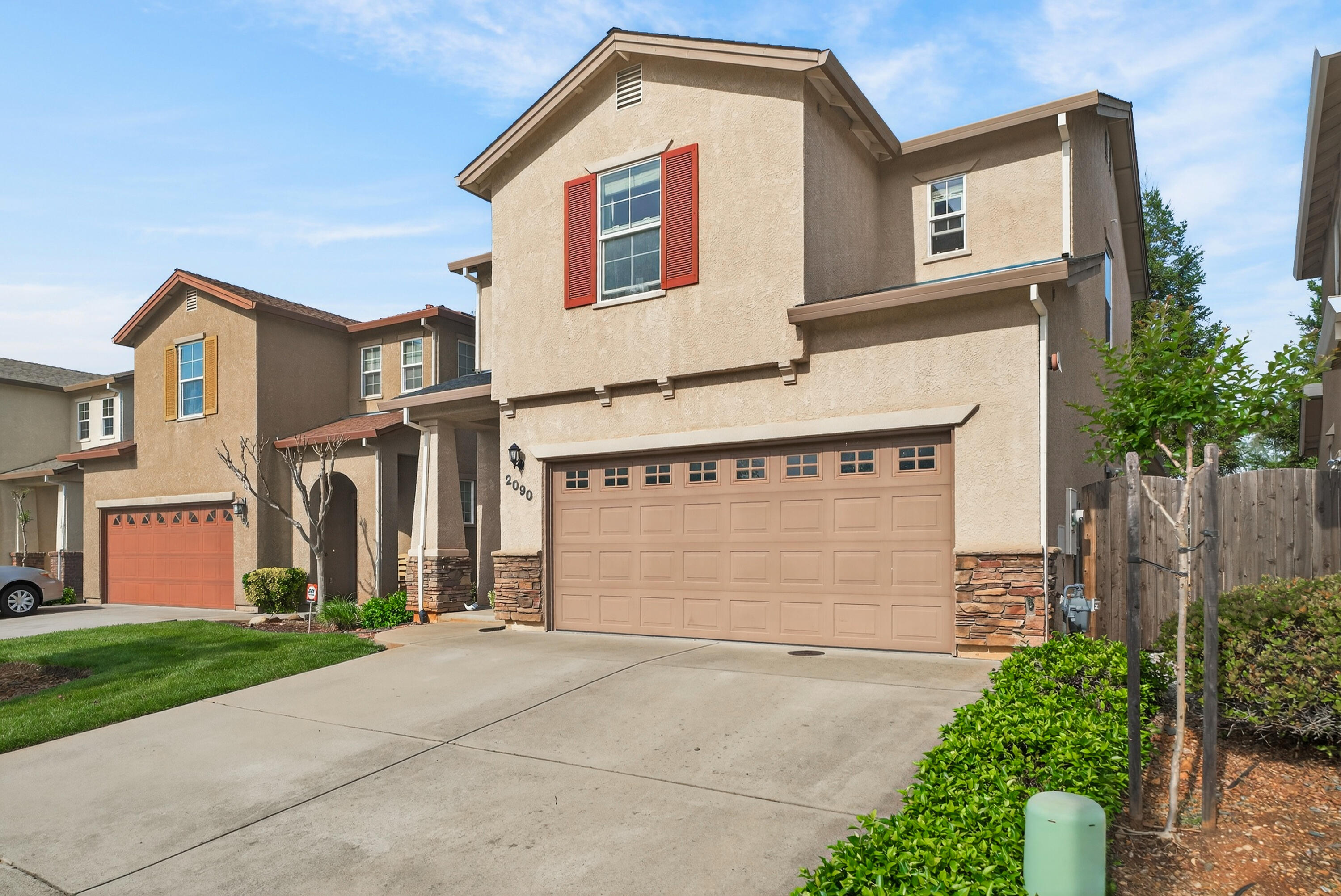 2090 Tuscany Way Redding, CA 96003 - Photo 3 of 37 a front view of a house with a yard and garage