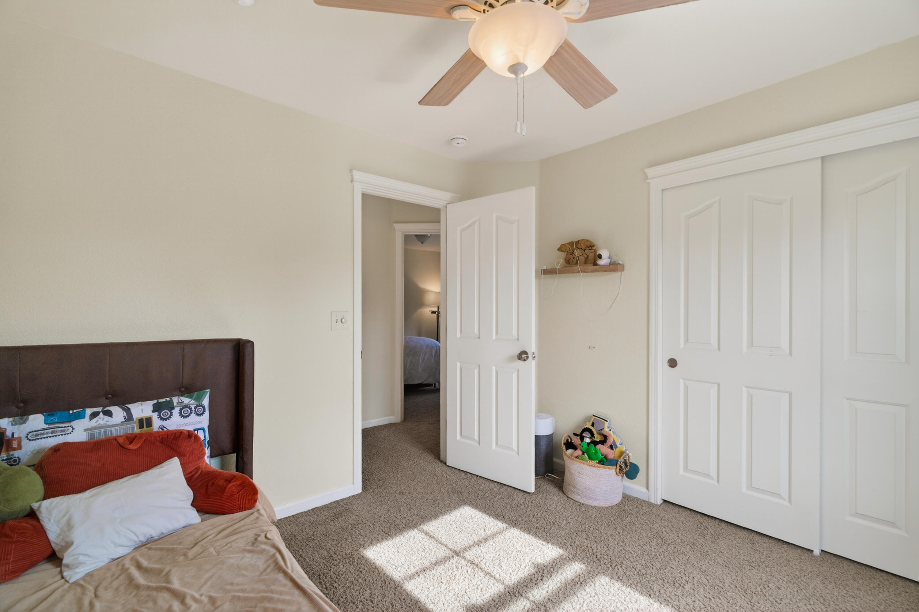 2090 Tuscany Way Redding, CA 96003 - Photo 31 of 37 a bedroom with a bed and a chandelier