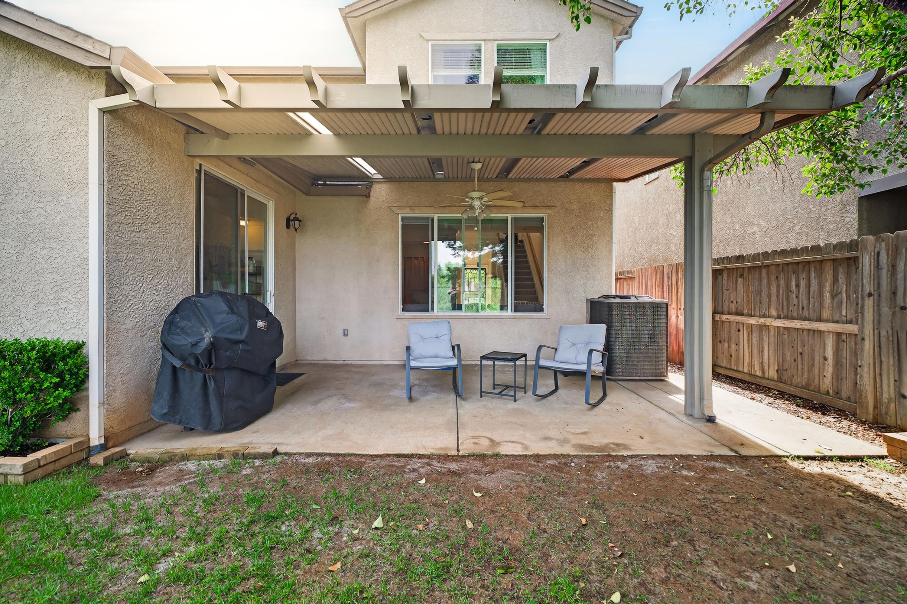 2090 Tuscany Way Redding, CA 96003 - Photo 33 of 37 a view of a chairs and table in backyard of the house