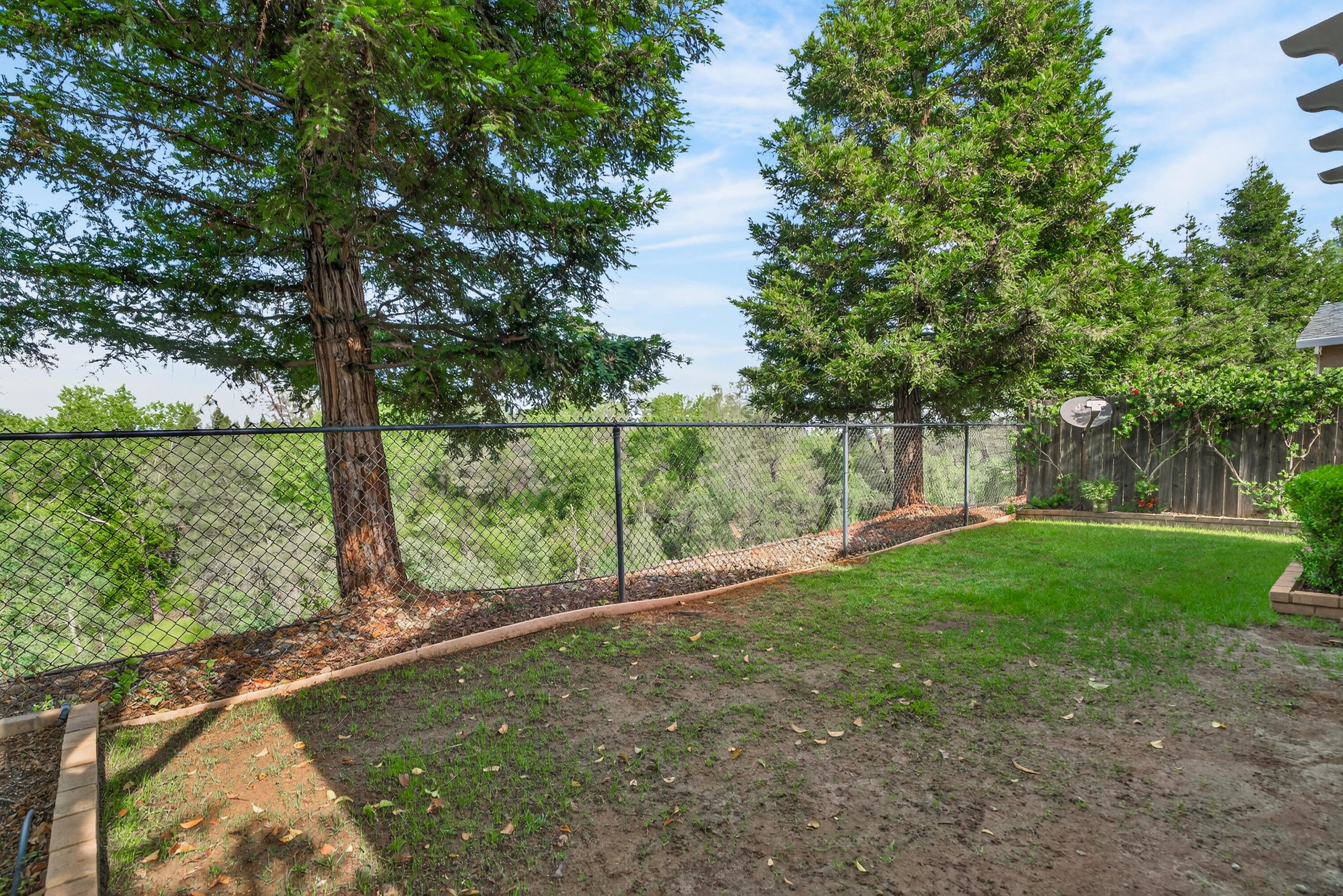 2090 Tuscany Way Redding, CA 96003 - Photo 35 of 37 a view of a field with a tree in the background