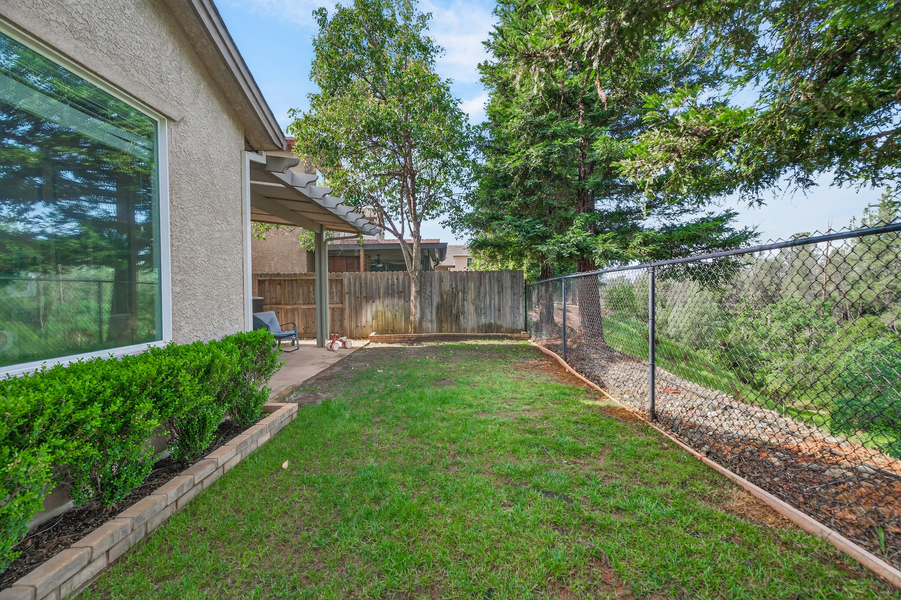 2090 Tuscany Way Redding, CA 96003 - Photo 36 of 37 a view of a backyard with a garden