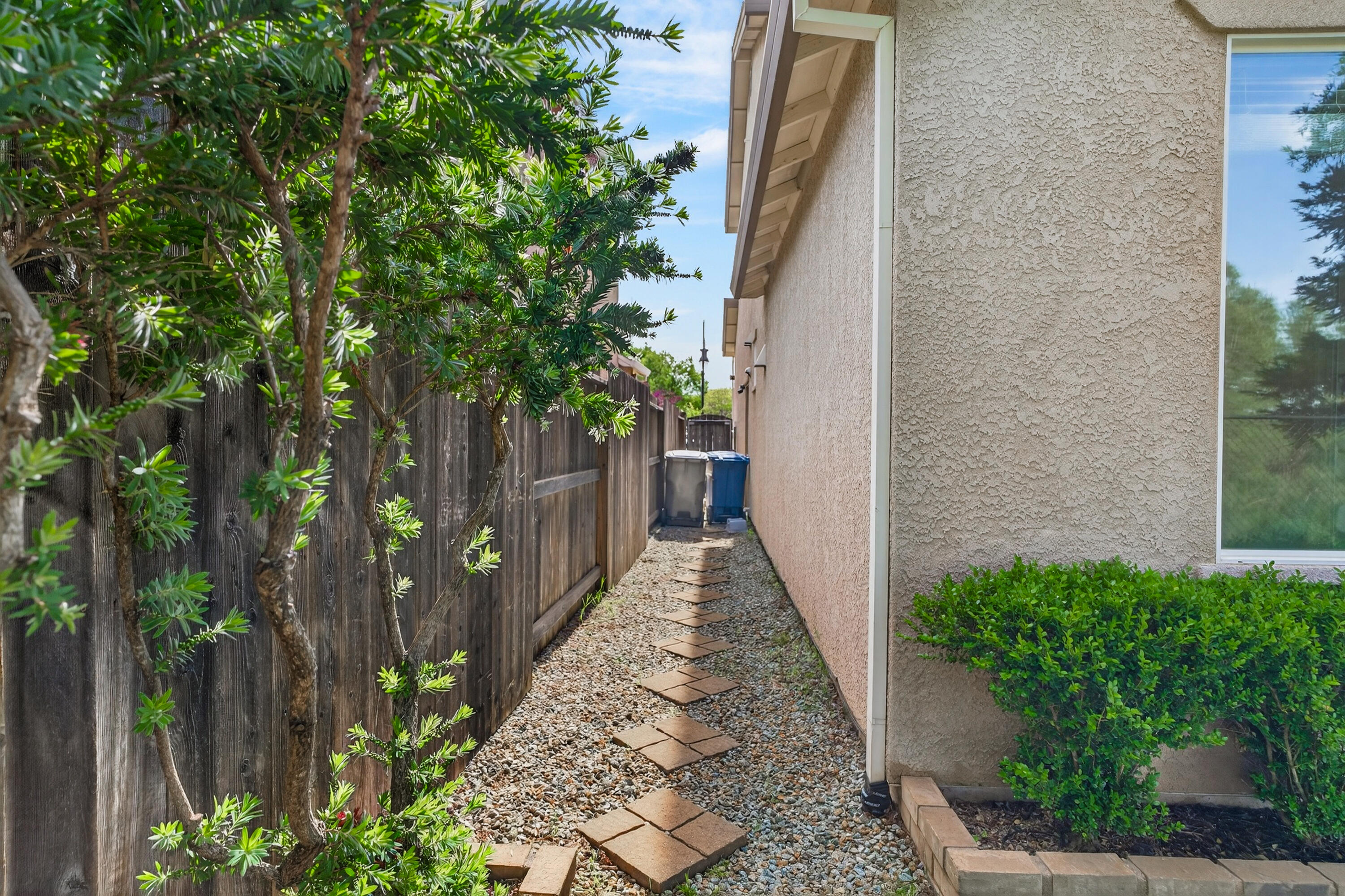 2090 Tuscany Way Redding, CA 96003 - Photo 37 of 37 a pathway of a house with wooden fence