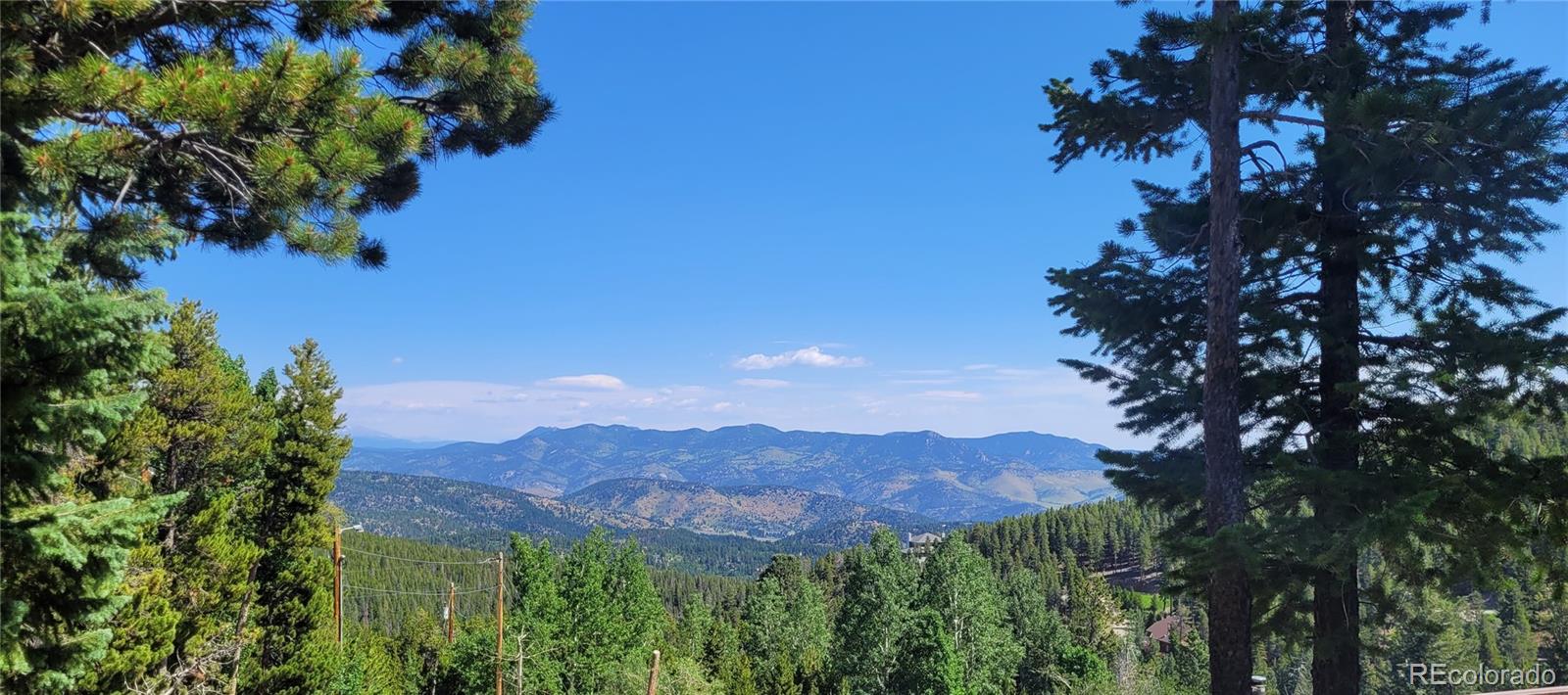 2339 Sinton Road Evergreen, CO 80439 - Photo 1 of 16 a view of a lake with a mountain in the background