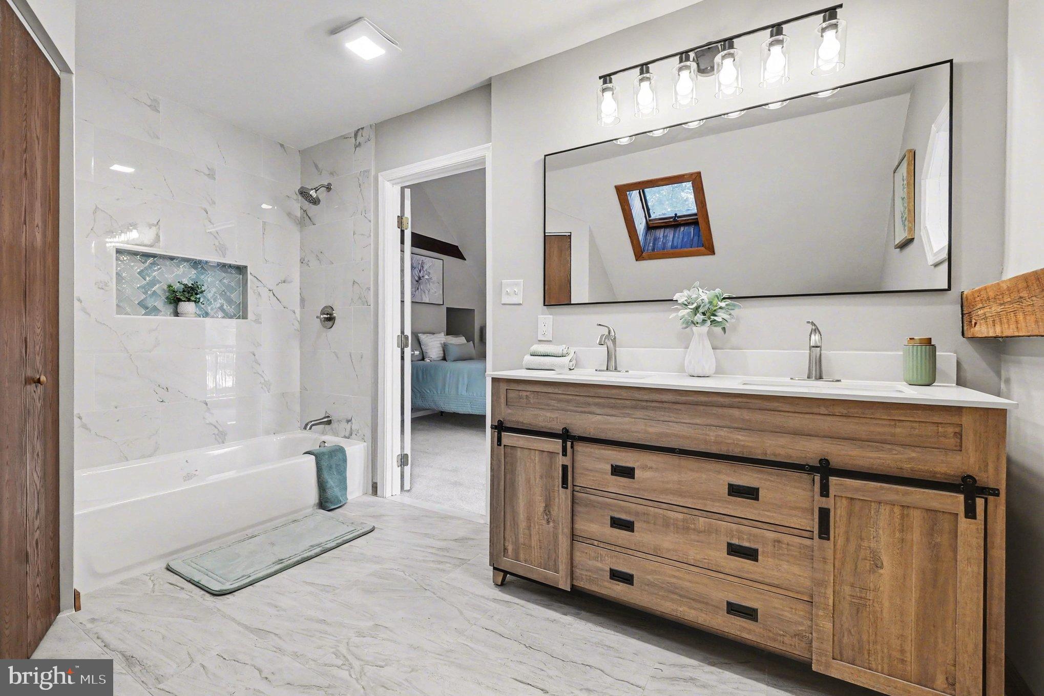 151 Fawn Drive Elkton, MD 21921 - Photo 18 of 26 a spacious bathroom with a granite countertop sink a mirror a bathtub and shower