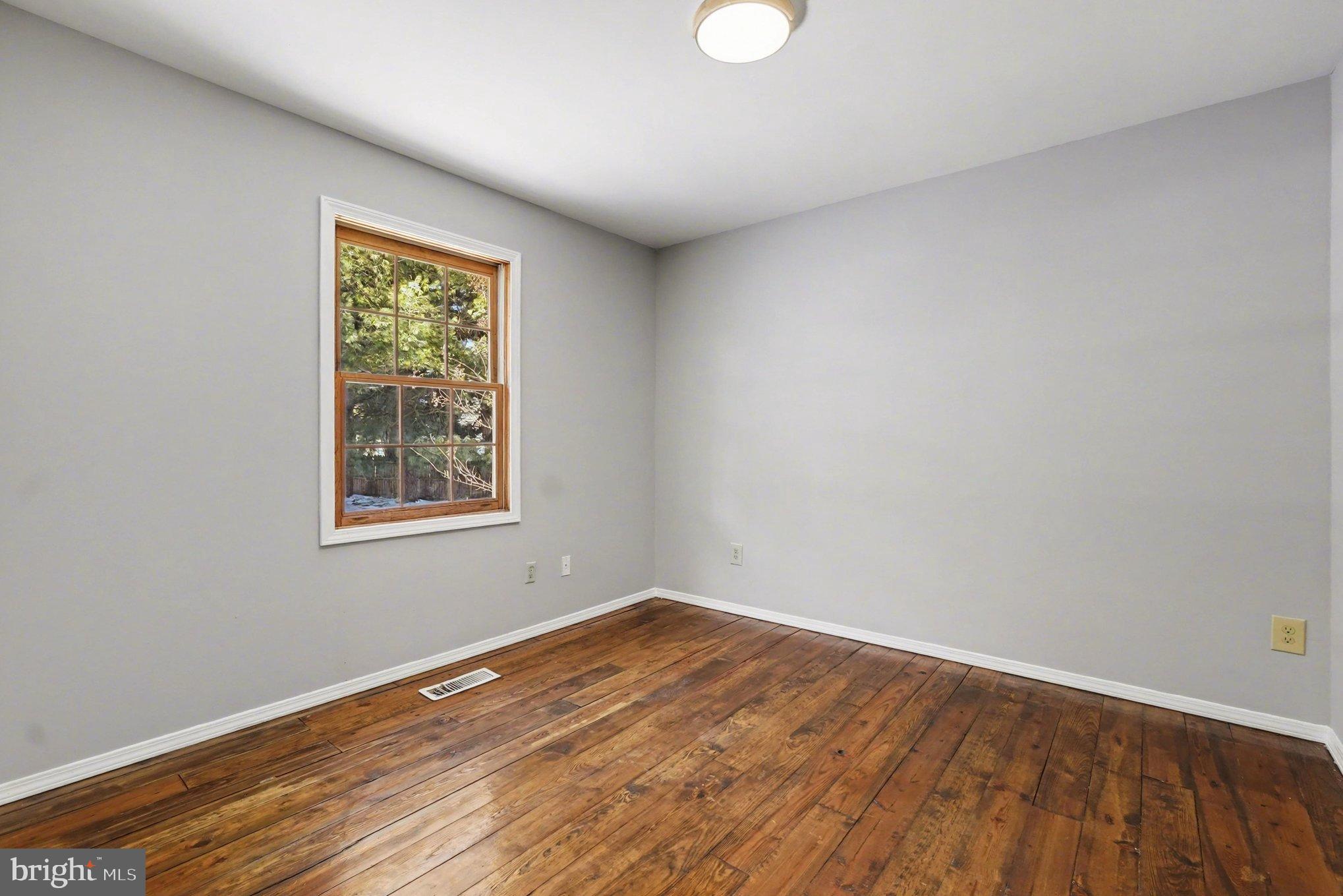 151 Fawn Drive Elkton, MD 21921 - Photo 20 of 26 an empty room with wooden floor and windows