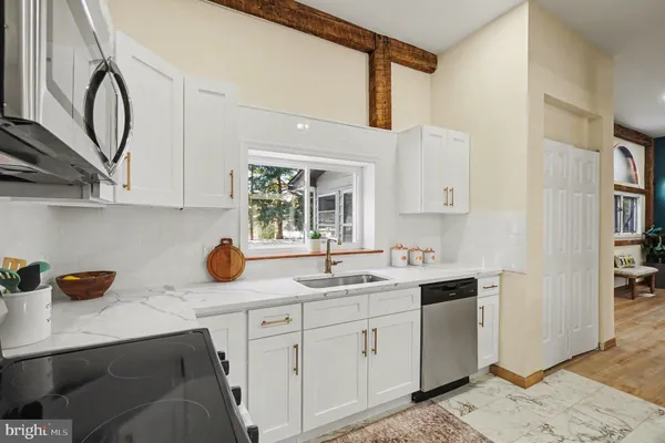a kitchen with a sink dishwasher and cabinets