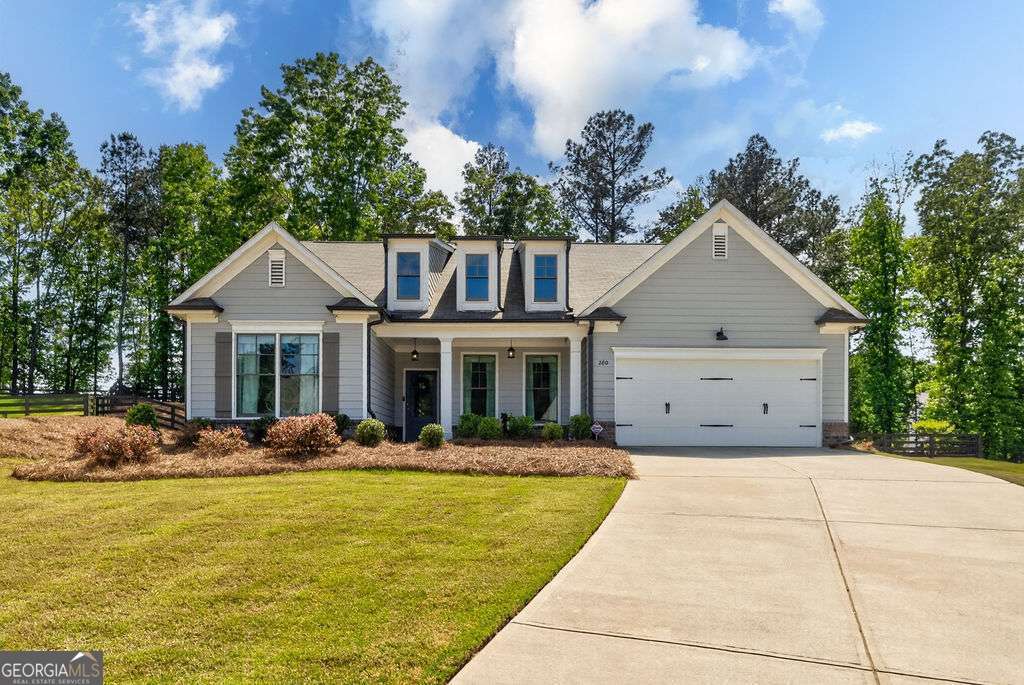 280 Greystone Court Winder, GA 30680 - Photo 1 of 40 a front view of a house with swimming pool having outdoor seating