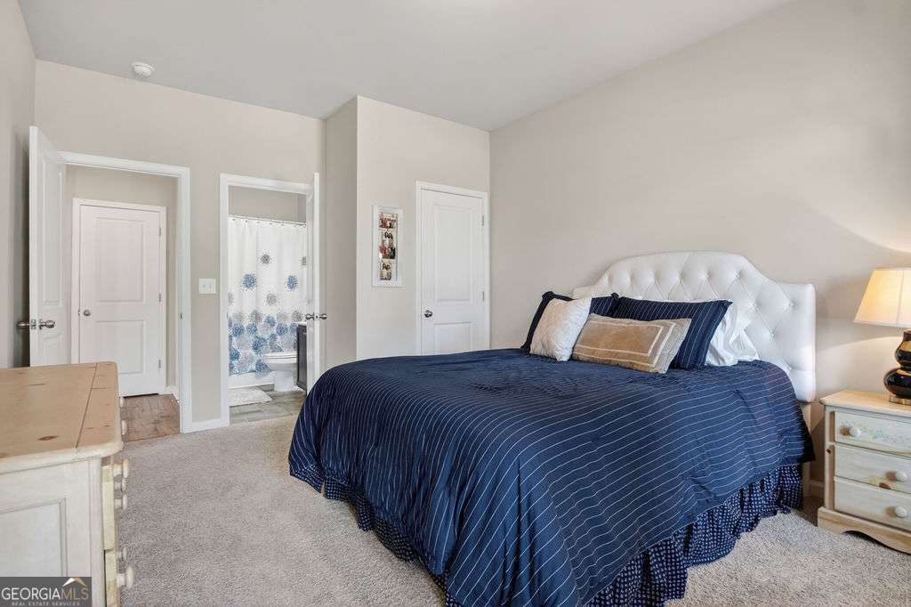 280 Greystone Court Winder, GA 30680 - Photo 11 of 40 a bedroom with a bed and a couch