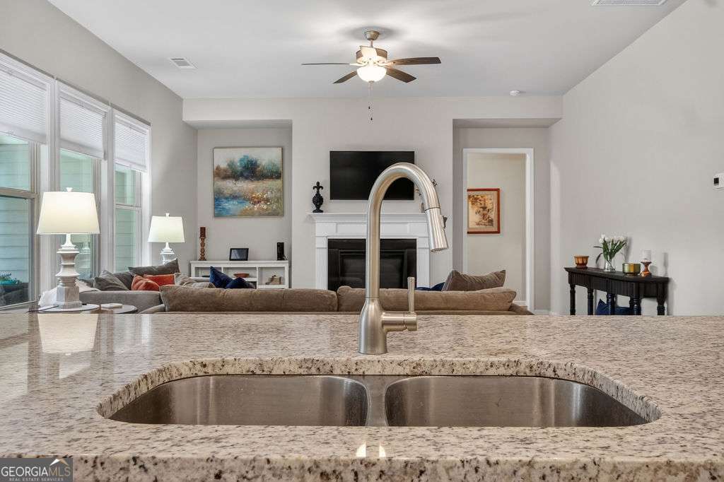 280 Greystone Court Winder, GA 30680 - Photo 14 of 40 a view of kitchen with granite countertop a sink and a counter top space