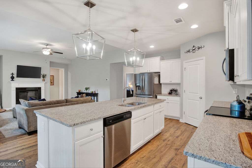 280 Greystone Court Winder, GA 30680 - Photo 16 of 40 a kitchen with a center island appliances and cabinets