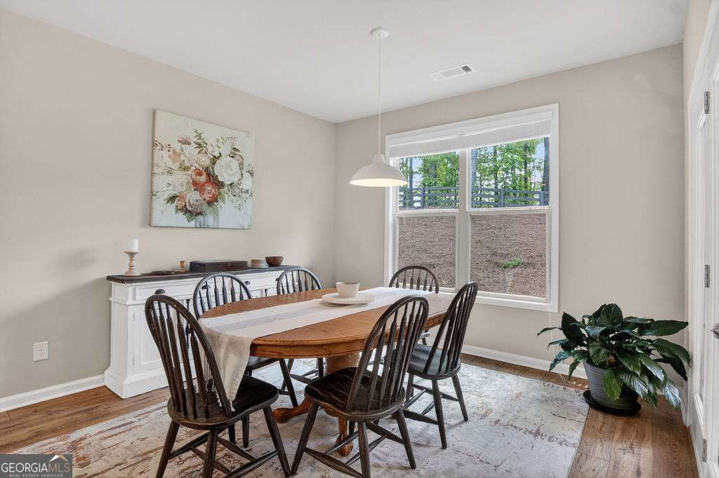 280 Greystone Court Winder, GA 30680 - Photo 17 of 40 a view of a dining room with furniture window and wooden floor