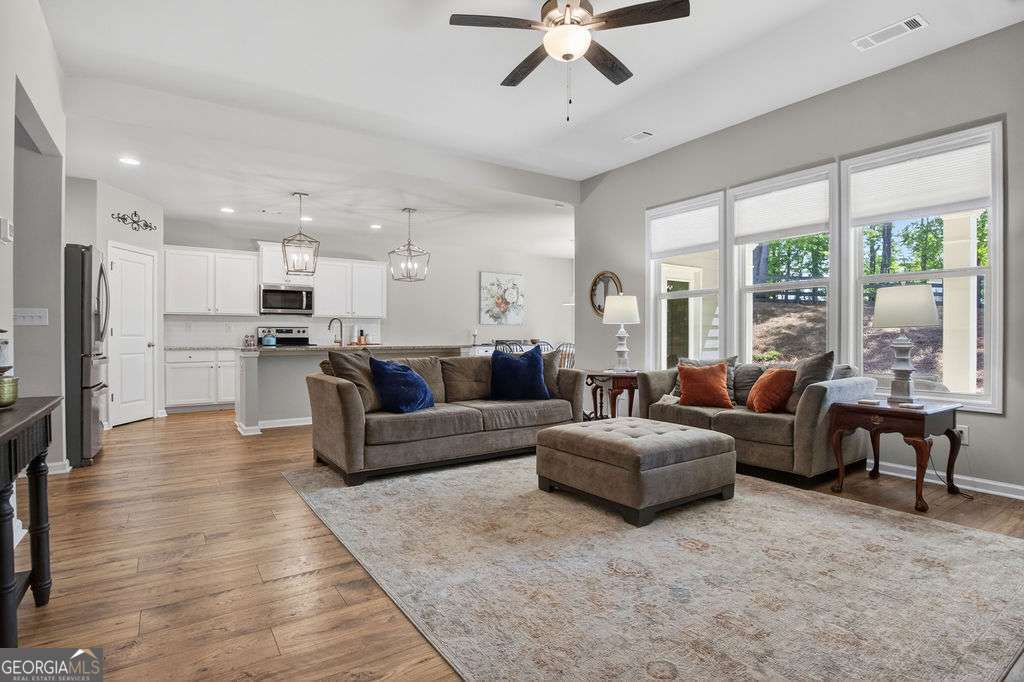 280 Greystone Court Winder, GA 30680 - Photo 21 of 40 a living room with furniture and a large window