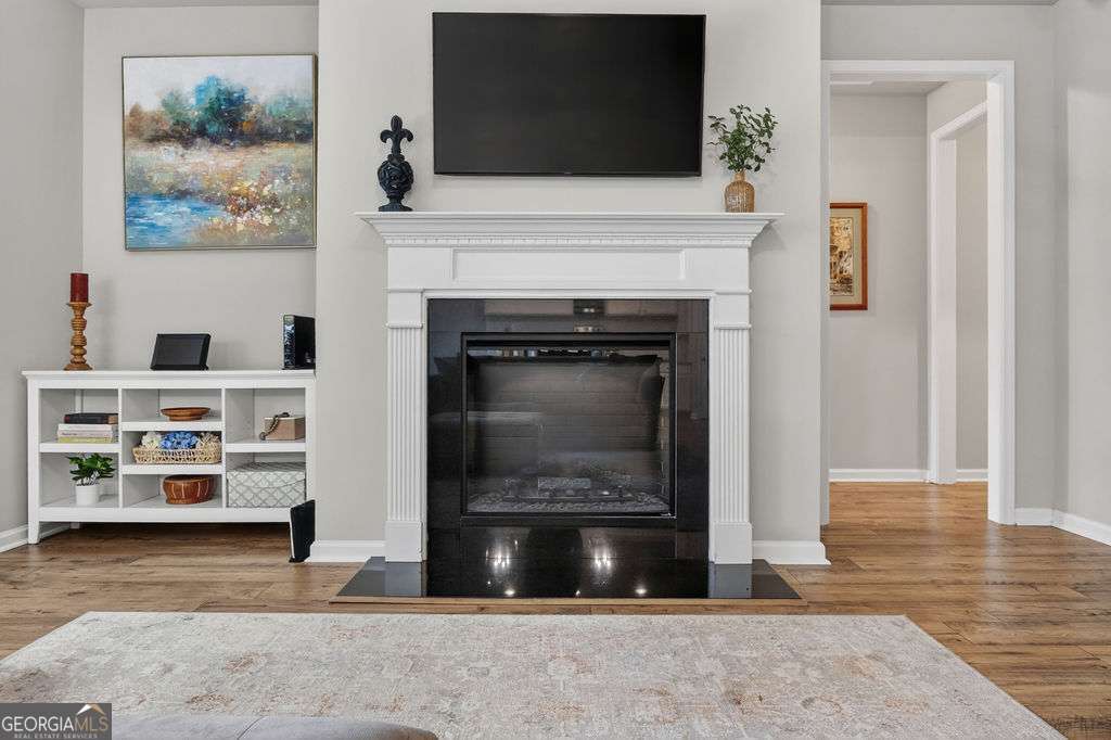 280 Greystone Court Winder, GA 30680 - Photo 22 of 40 a view of a livingroom with furniture and a fireplace