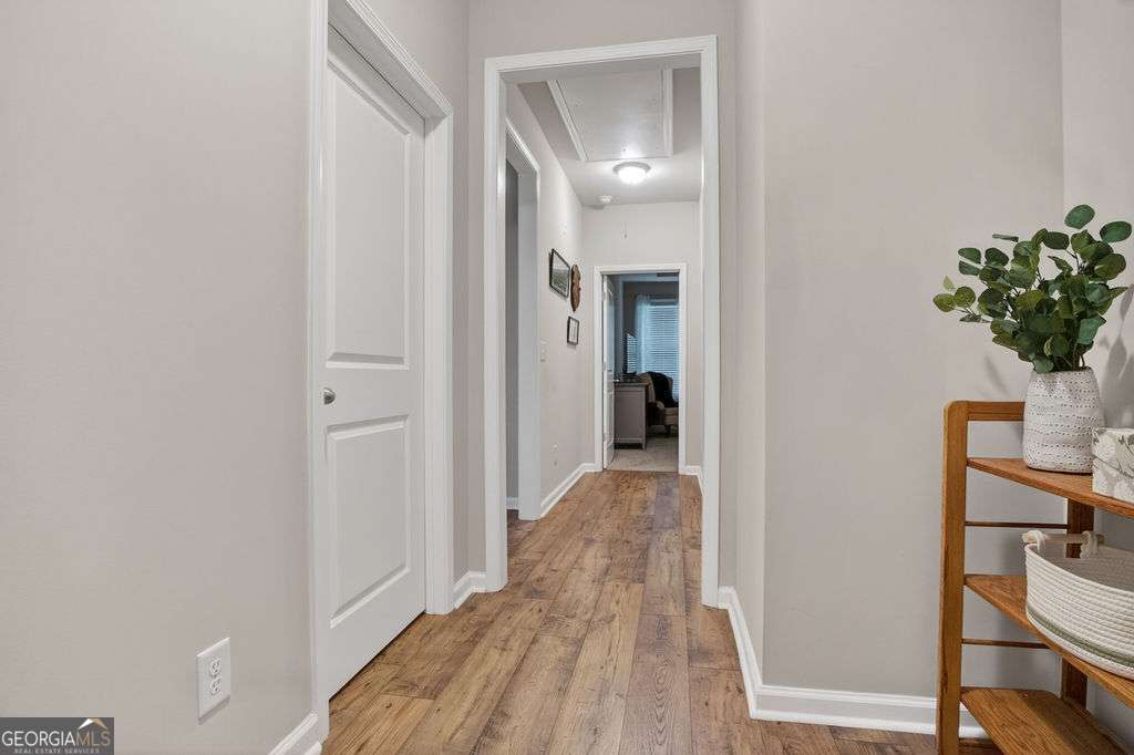 280 Greystone Court Winder, GA 30680 - Photo 25 of 40 a view of a bedroom with wooden floor and furniture