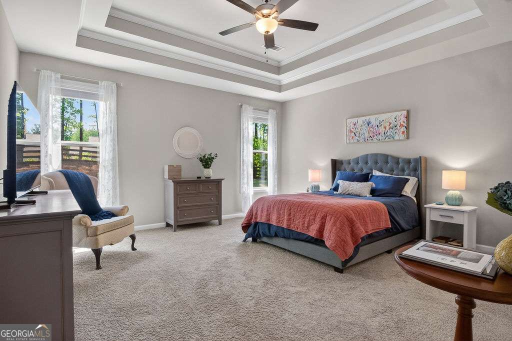 280 Greystone Court Winder, GA 30680 - Photo 26 of 40 a bedroom with a bed and a chandelier