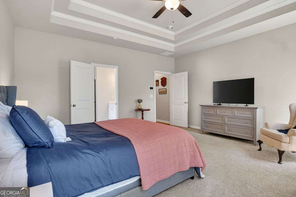 280 Greystone Court Winder, GA 30680 - Photo 27 of 40 a bedroom with a bed and a flat screen tv