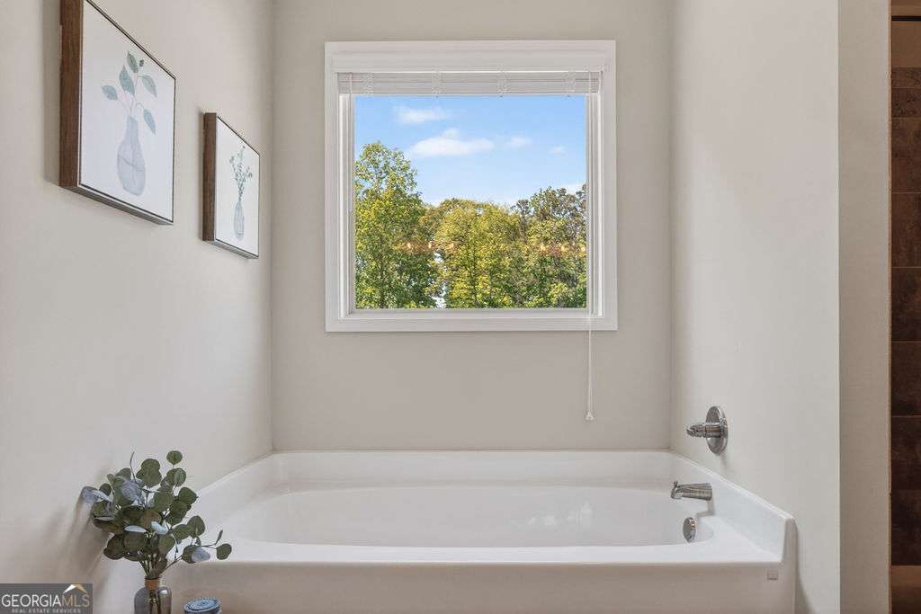 280 Greystone Court Winder, GA 30680 - Photo 29 of 40 a white bath tub sitting next to a window
