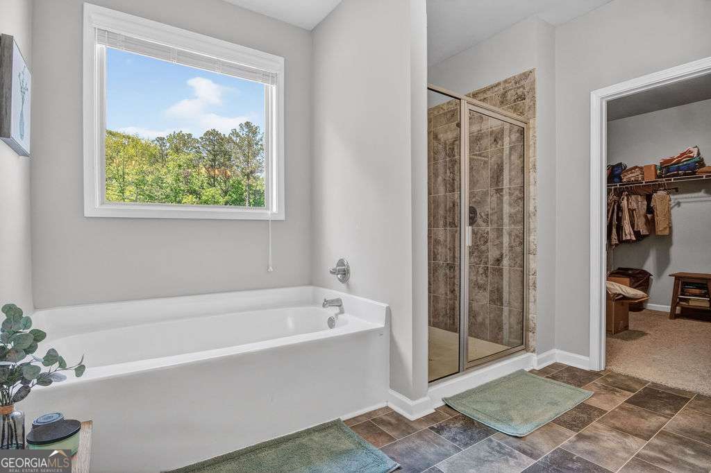 280 Greystone Court Winder, GA 30680 - Photo 30 of 40 a white bath tub sitting in a bathroom next to a window