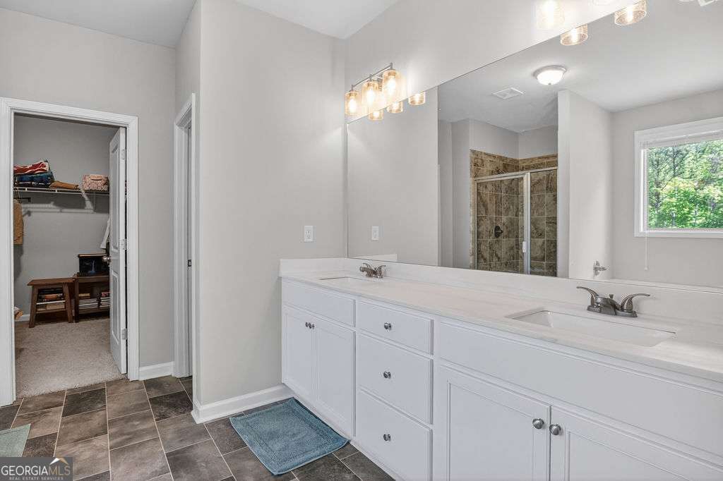 280 Greystone Court Winder, GA 30680 - Photo 31 of 40 a bathroom with a sink double vanity and a mirror
