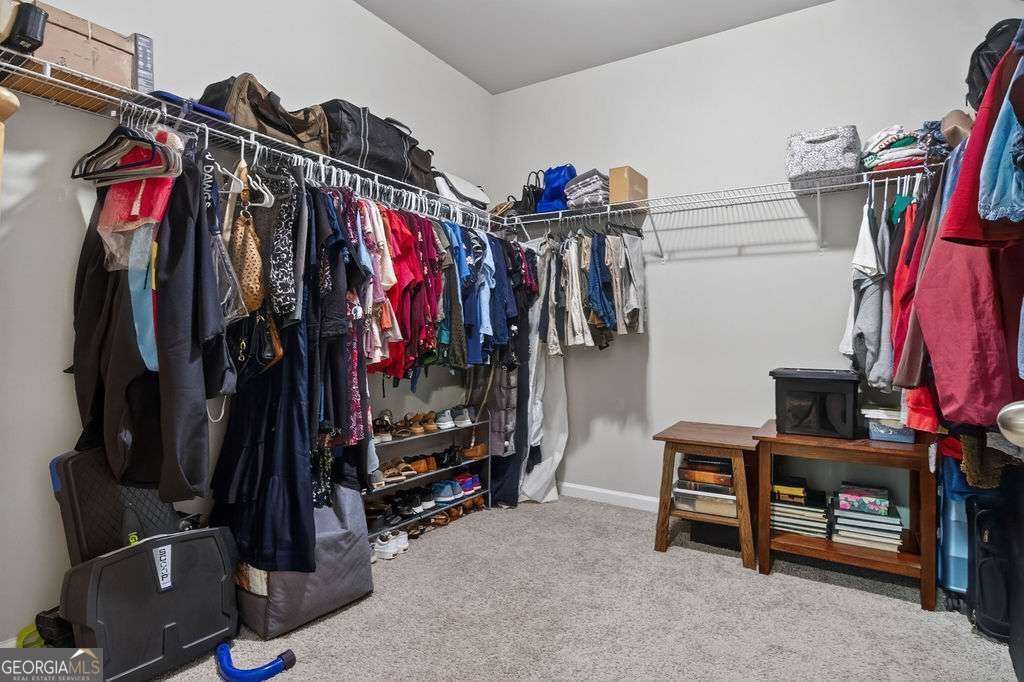 280 Greystone Court Winder, GA 30680 - Photo 32 of 40 a view of walk in closet with clothes