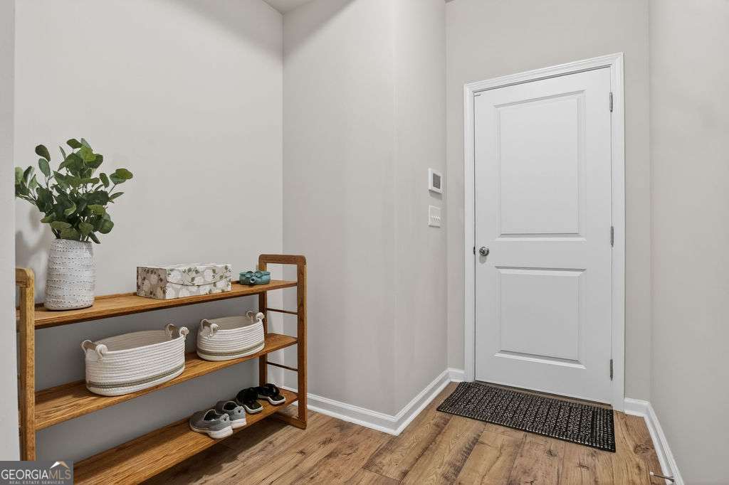 280 Greystone Court Winder, GA 30680 - Photo 33 of 40 a view of room with chair and wooden floor