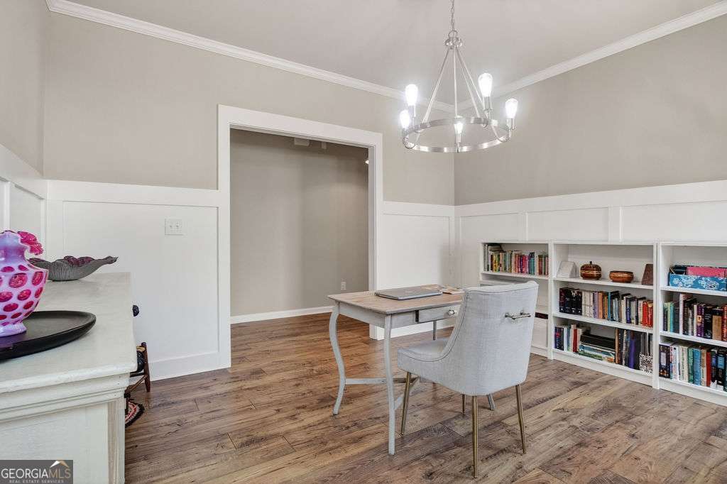 280 Greystone Court Winder, GA 30680 - Photo 6 of 40 a view of a dining room with furniture and a book shelf