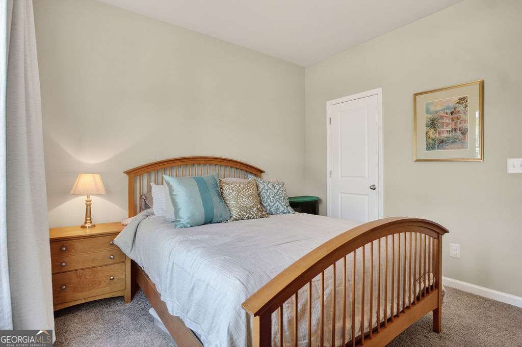 280 Greystone Court Winder, GA 30680 - Photo 7 of 40 a bedroom with a bed and a lamp