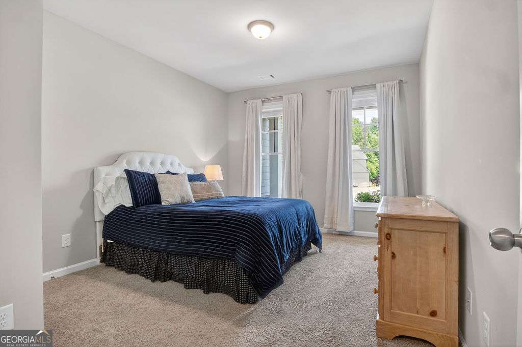 280 Greystone Court Winder, GA 30680 - Photo 10 of 40 a spacious bedroom with a bed and a window