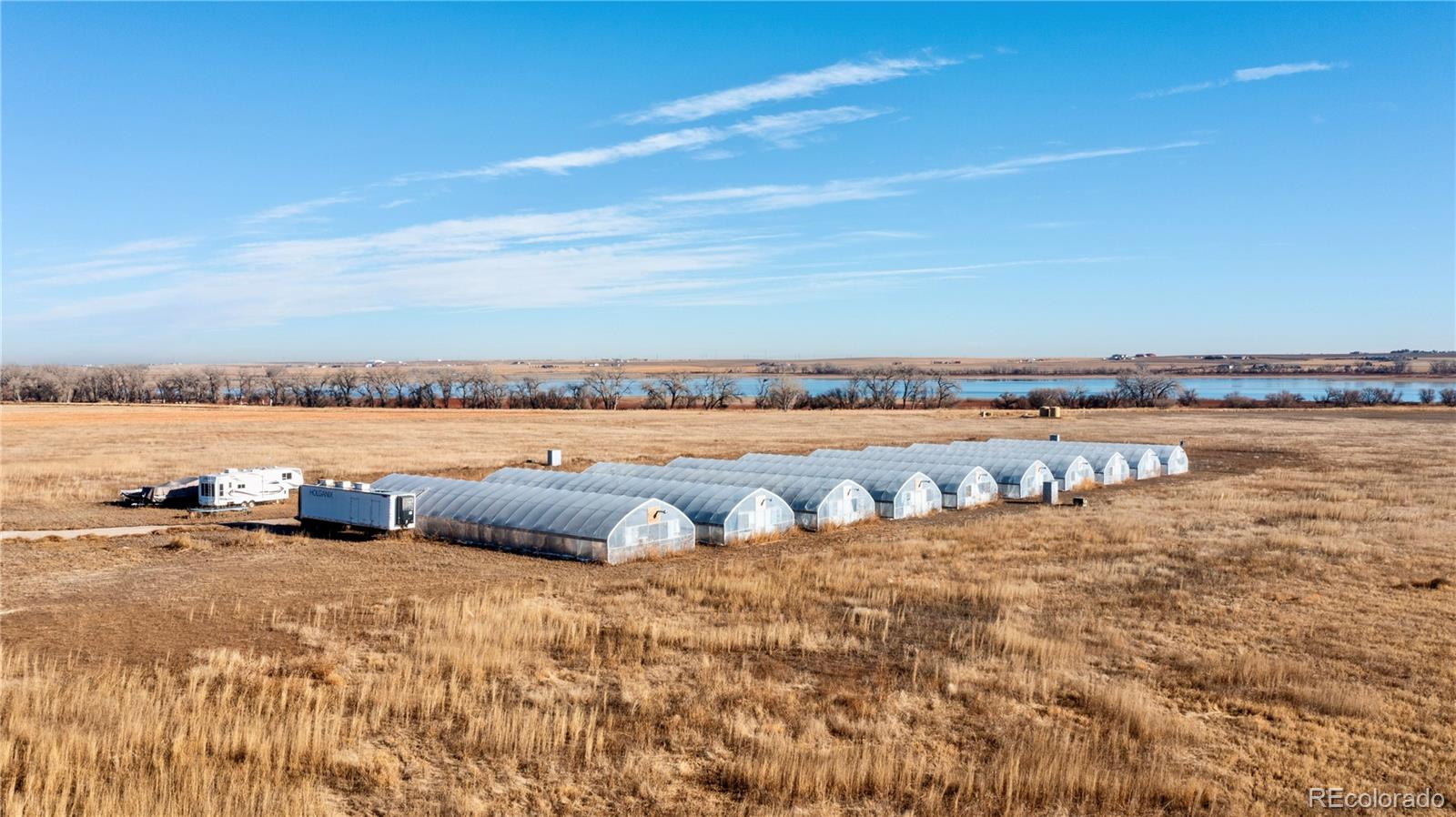 16590 Watkins Road Hudson, CO 80642 - Photo 1 of 30 a view of swimming pool and lake view