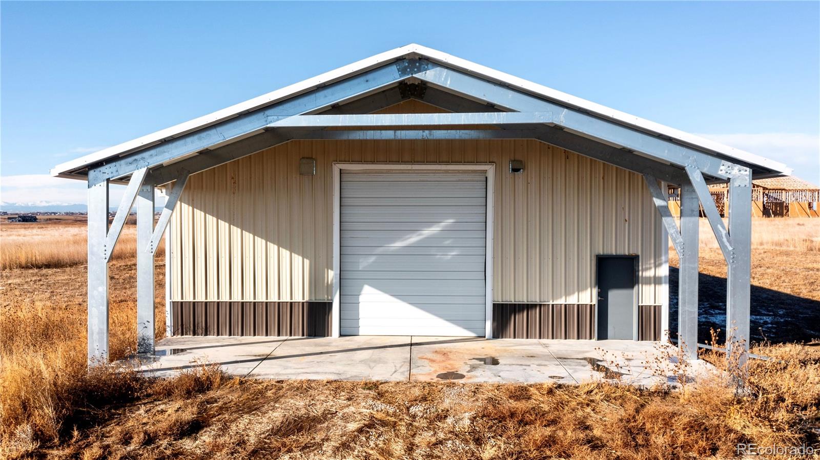 16590 Watkins Road Hudson, CO 80642 - Photo 14 of 30 a front view of a house with a yard