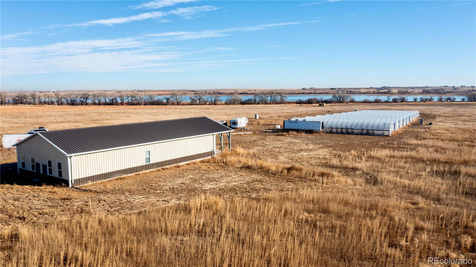 16590 Watkins Road Hudson, CO 80642 - Photo 29 of 30 a view of a lake with houses in the back