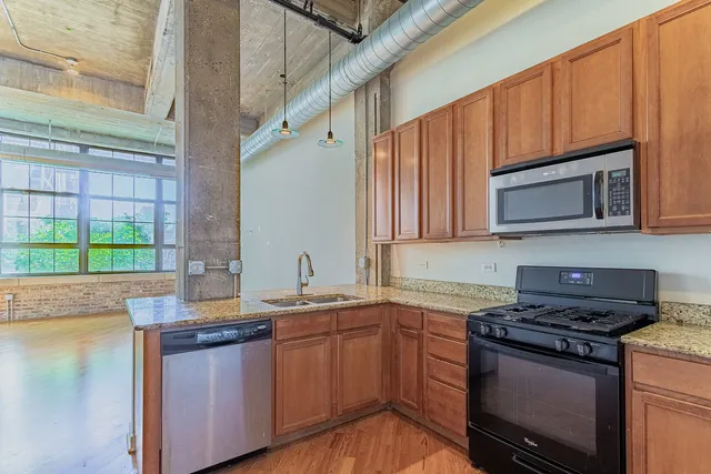 a kitchen with stainless steel appliances a sink stove and microwave