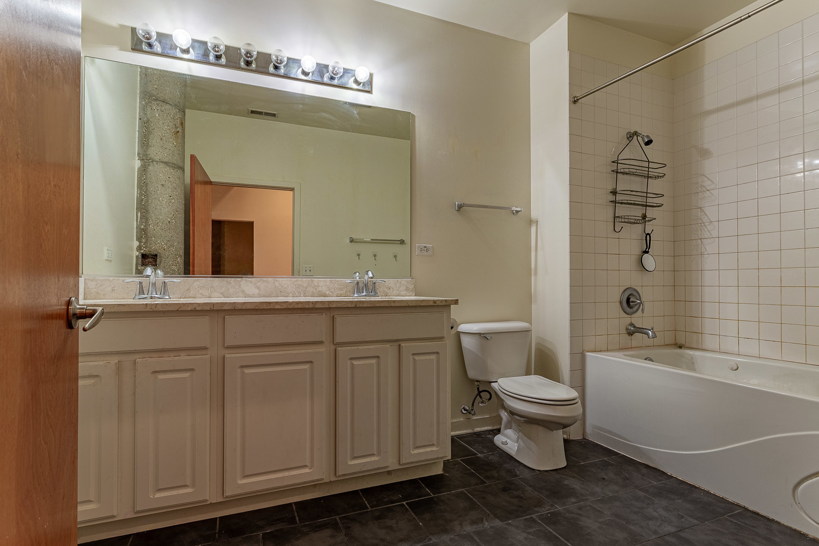 3963 West Belmont Avenue, Unit 117 Chicago, IL 60618 - Photo 8 of 13 a bathroom with a double vanity sink a toilet a mirror and shower