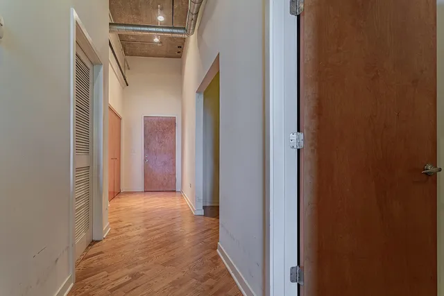 a view of a hallway with wooden shelves