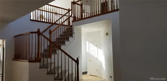 a view of staircase with railing and a stairs