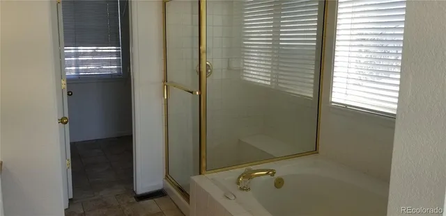 a bathroom with a tub and shower